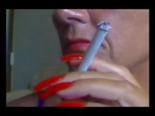 Personable enticing Smoking with exceptional voluptuous Red Nails.